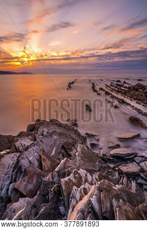 Stones At Sunset Of The Geopark Called Flysch On The Beach Of Sakoneta In The Town Of Deba, At The W