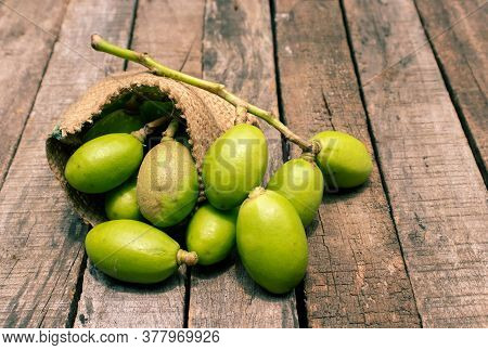 Hog Plum Or Spondias Mombin In A Jute Sack Isolated On Wooden Background