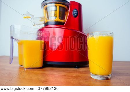 Raw Food Diet Concept Oranges And Juicemachine In White Background