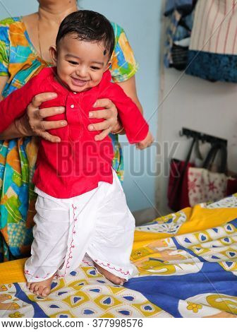 An Infant Indian Toddler Boy Dressed In Traditional Indian Dhoti Kurta Bengali Cultural Dress