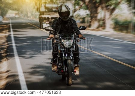 Motorcyclist Driving At High Speed On The Street. Motorcycle Driver At Full Speed On The Highway.