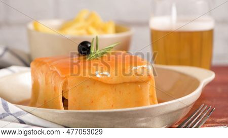 Traditional Portuguese Snack Food. Francesinha Sandwich Of Bread, Cheese, Pork, Ham, Sausages, With 