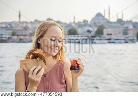 Woman In Istanbul Having Breakfast With Simit And A Glass Of Turkish Tea. Glass Of Turkish Tea And B