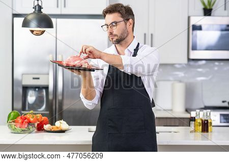 Man Chef Cooker Hold Meat Beef. Male Chef In Chefs Uniform With Raw Meat Beef Fillet. Chef Man Cooki