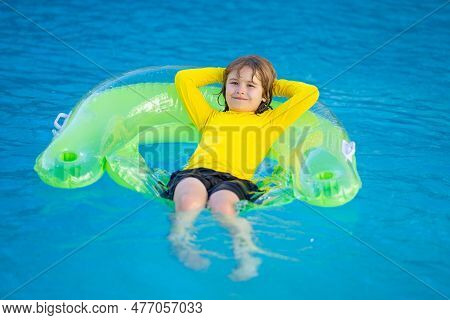 Swimming, Summer Vacation. Child Swim In Pool On Inflatable Ring. Kid With Inflatable Ring In Swimmi