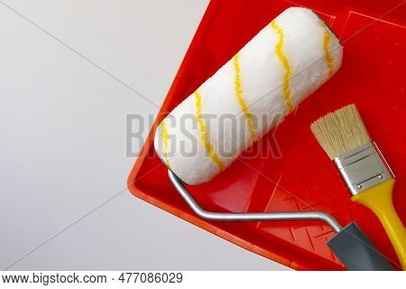 Paint Can, Roller And Paint Tray For Painting Wall On The Floor
