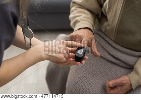 Measurement Of Oxygen Level And Pulse Rate With A Portable Pulse Oximeter - A Man Monitors His Healt
