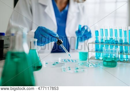 Scientist Mixing Chemical Liquids In The Chemistry Lab. Researcher Working In The Chemical Laborator