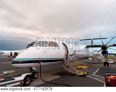 Portland, Oregan - 27 May 2014:  Close-up Of Alaskan Airlines Propeller Plane Parked And Refueling A