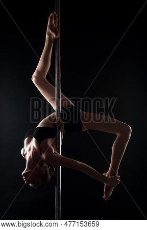 Pole Dance. Sexy Ballerina In Black Underwear Stretching On Black Background. Concept Of Ballet Art.