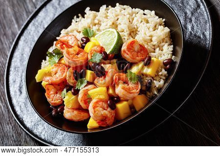Caribbean Grilled Shrimps With Black Beans, Mango Pineapple Salsa Served With Brown Rice In Black Bo
