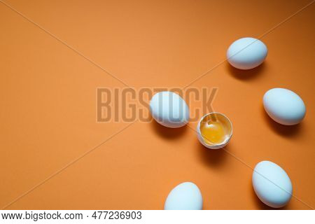 White Eggs And Egg Yolk On The Yellow Background. Egg Yolk In Egg Shell, Cracked Egg White Isolated 