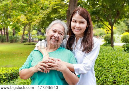 Portrait Of Mother And Daughter Standing Together In The Park They Both Smiled Happily. Family Conce