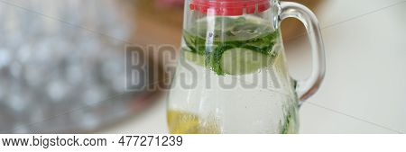 Drink With Lemon Slices And Cucumber In Jug On Table. Mint Summer Chilled Lemonade