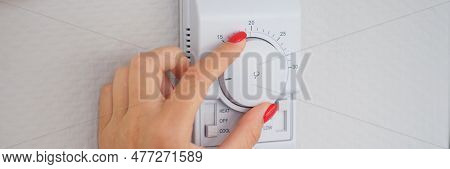 Woman Hand Adjusts Or Turns On Wall Temperature Controller Controller Button. Climate Control In Roo