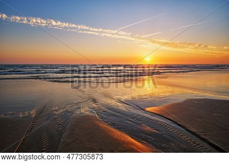 Atlantic Ocean Sunset With Surging Waves At Fonte Da Telha Beach, Portugal