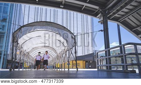 Bangkok, Thailand - May 26,2023 : Two Thai High School Students Walking In Folding Tunnel At The Ent