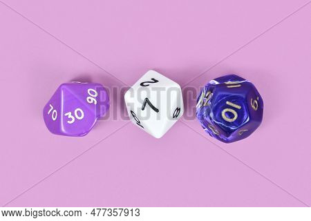 Three Different Roleplaying Rpg Dice On Violet Background