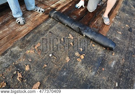 Repairing A Run Down, Old And Bad Roof Sheathing By Removing Old Wet Wooden Planks, Boards, Timber. 