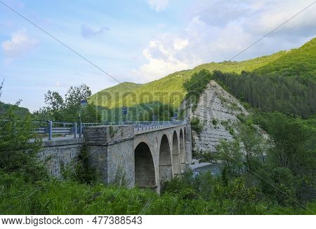 Old Bridge Over The River Enza In Neviano Degli Arduini, Parma, Emilia Romagna, Italy During The Sun