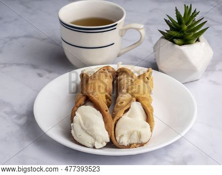 Two Cannolis Filled With Ricotta  Served With Green Tea,