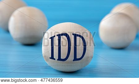 The Letters Idd (intellectual Developmental Disabilities) Are Depicted On A Wooden Round Ball On A B