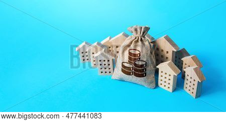 Big Money Bag Surrounded By Houses. Buying Apartments. Real Estate Investment. Budget And Funding. M