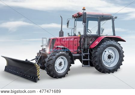 Modern Wheeled Tractor With Mouldboard Isolated On Bright Background With Sky