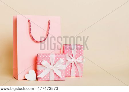 Shopping Bag With Gift Box On Colored Background Perspecrive View. Space For Text Holiday Concept.