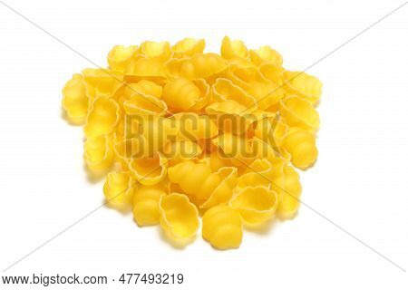 Raw Pasta Gnocchetti On Wooden Spoon On White Background. Top View Of Italian Cuisine Ingredient.