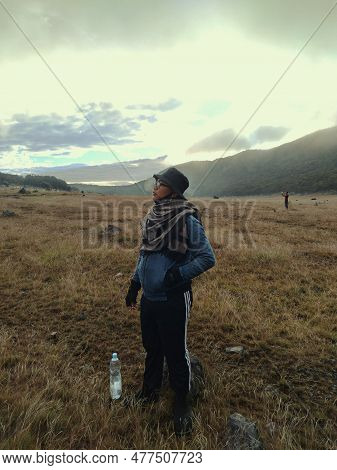 Bogor, Indonesia - 07 01 2021: A Man Posing Looking Up At The Sky While In The Savanna Of Mount Gede