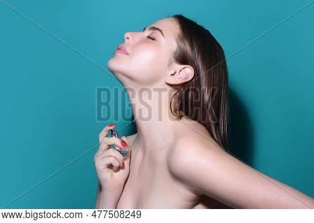 Young Pretty Woman Smelling Perfume. Sensual Woman With Bottle Of Perfume, Beauty Portrait. Female P