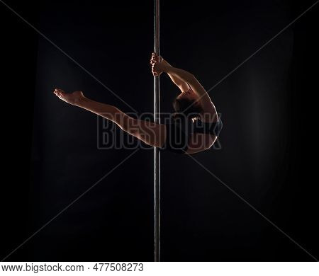 Flexible Sexy Body Of Young Woman On Black Background. Pole Dance. Sexy Woman Exercise Pole Dance. F