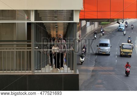 Jakarta, Indonesia - June 4, 2023 : People Crossing The Pedestrian Bridge With Traffic Background In