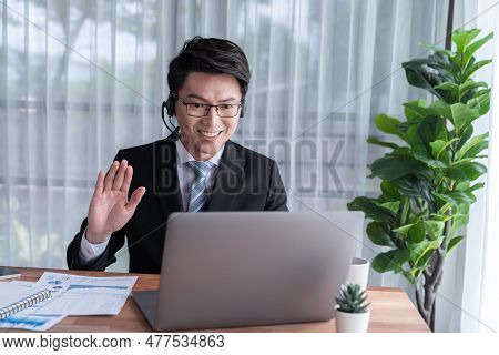 Confident Asian Telesales Businessman Work In Modern Office Wearing Headphone, Presenting Bi Dashboa