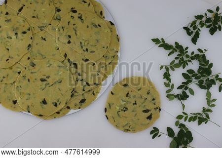 Ready To Fry Pressed Poori Made With Whole Wheat Flour, Mixed With Cooked Lentils, Moringa Leaves An