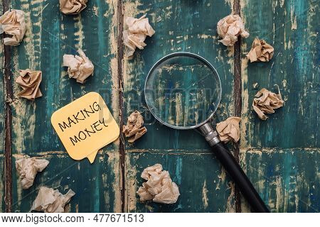 Sticker Making Money And Crumpled Paper On Wooden Background