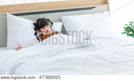 Asian Young Little Cute Preschooler Daughter Girl Laying Down Preparing To Sleep On Cozy Pillow Unde