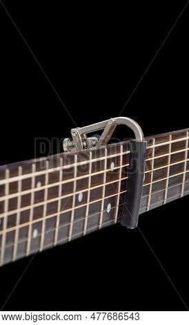 Capo On The Acoustic Guitar Neck , Capro Made From Aluminium, Selective Focus At Capo