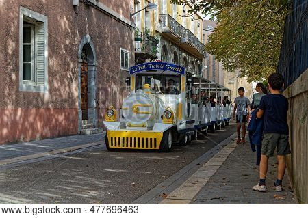 Grenoble, France, October 27, 2022 : The Little Tourist Train Of Grenoble Takes Tourists To The Hear