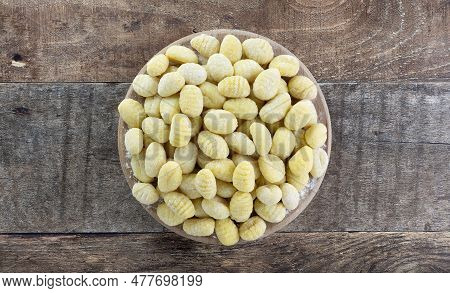 Raw Italian Potato Gnocchi On Wooden Background. Top View. Italian Food.