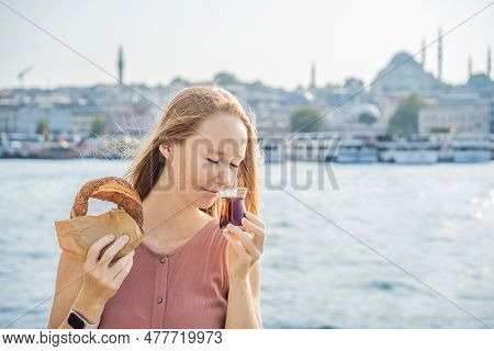 Woman In Istanbul Having Breakfast With Simit And A Glass Of Turkish Tea. Glass Of Turkish Tea And B