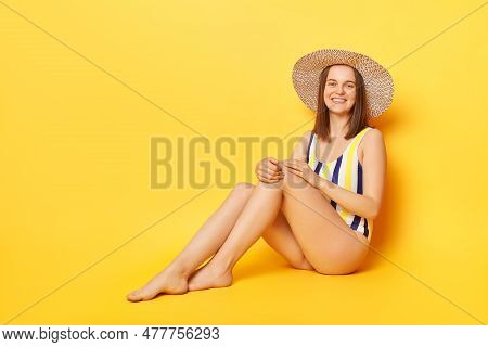 Smiling Beautiful Young Woman Wearing Striped One-piece Swimsuit And Straw Hat Posing Isolated Over 