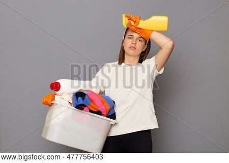 Housewife Takes Care Of Clothing. Domestic Appliances Aid In Housework. Tired Exhaused Woman Wearing