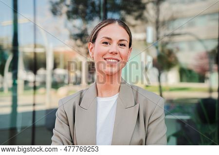 Portrait Of A Happy Business Woman Standing At Office Building Workplace With Successful Expression.