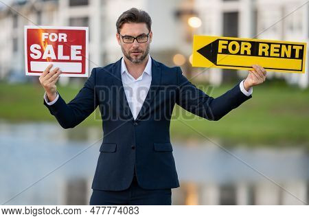House Seller, Real Estate Agents Hold Sign For Sale Or Rent. Real Estate Trading Ideas And Bank Loan