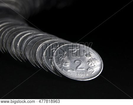 Closeup Shot Of Silver 2 (two) Rupee Indian Coins Arranged And Stacked In A Snake Like Curved Row Is