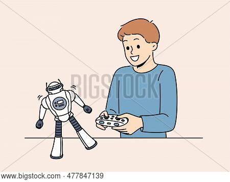 Boy With Toy Remote Controlled Robot For Concept Of Learning Robotics. Schoolboy Is Passionate About