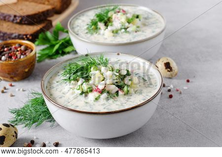 Cold Okroshka Soup With Eggs, Vegetables, Meat, Herbs And Kefir On A Bright Background, Summer Soup