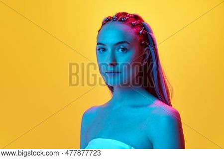 Close-up Portrait Ofc Tender, Attractive Young Girl With Cute Hairstyle Looking At Camera With Calm 